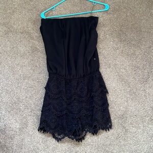 Strapless black romper with lace shorts